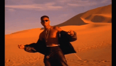 A Man Without A Shirt Is Standing In A Desert GIF