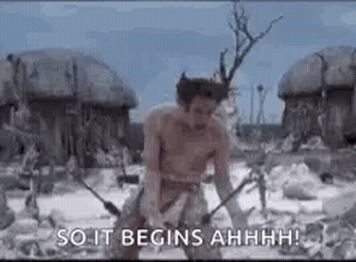A Man Without A Shirt Is Standing In A Field With A Sword In His Hand . GIF