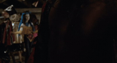 A Man Without A Shirt Is Standing In A Room GIF