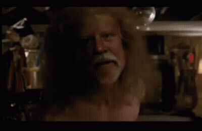 A Man Without A Shirt Is Standing In A Room GIF