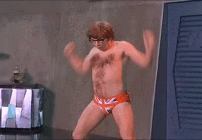 A Man Without A Shirt Is Standing In A Room Wearing British Flag Underwear . GIF