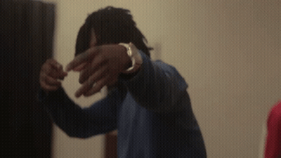 A Man Without A Shirt Is Standing In A Room With Smoke Coming Out Of The Window . GIF