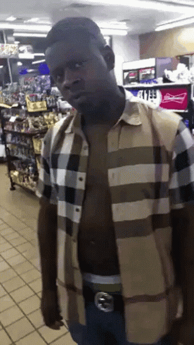 A Man Without A Shirt Is Standing In Front Of A Budweiser Cooler GIF