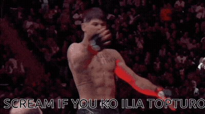 A Man Without A Shirt Is Standing In Front Of A Crowd And Screaming . GIF