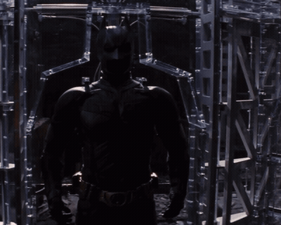 A Man Without A Shirt Is Standing In Front Of A Mirror Looking At Himself GIF