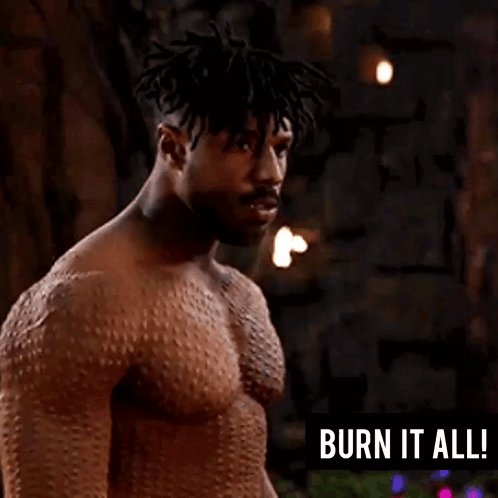 A Man Without A Shirt Is Standing In Front Of A Sign That Says Burn It All GIF