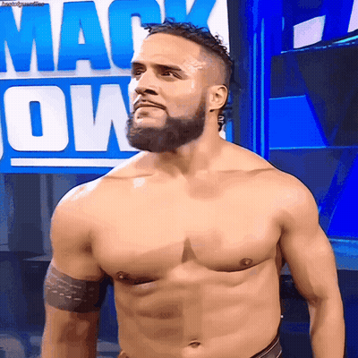 A Man Without A Shirt Is Standing In Front Of A Sign That Says Mack Down GIF