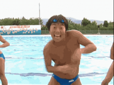 A Man Without A Shirt Is Standing In Front Of A Swimming Pool With A Sign That Says Aquafina On It GIF