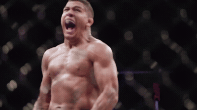 A Man Without A Shirt Is Standing In Front Of A Ufc Logo GIF