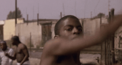 A Man Without A Shirt Is Standing In Front Of A Wall GIF