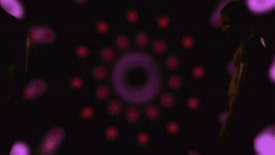 A Man Without A Shirt Is Standing In Front Of Purple Lights GIF