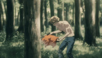 A Man Without A Shirt Is Standing In The Woods Holding A Pig GIF