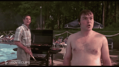 A Man Without A Shirt Is Standing Next To A Man Cooking On A Grill In Front Of A Swimming Pool GIF