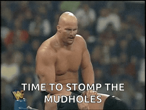 A Man Without A Shirt Is Standing Next To Another Man With The Words Time To Stomp The Mudholes Written On The Screen . GIF