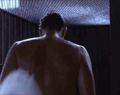 A Man Without A Shirt Is Taking A Shower GIF
