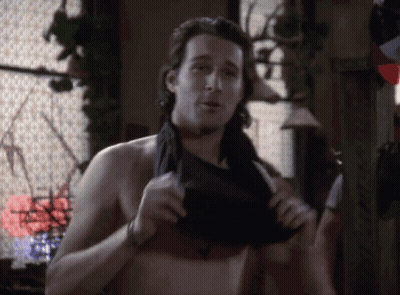 A Man Without A Shirt Is Taking Off His Shirt GIF