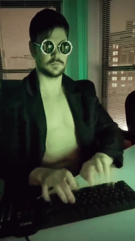 A Man Without A Shirt Is Typing On A Computer Keyboard GIF