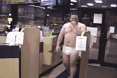 A Man Without A Shirt Is Walking In A Store With A Sign That Says ' Checkout ' On It GIF