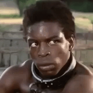 A Man Without A Shirt Is Wearing A Collar Around His Neck And Looking At The Camera . GIF