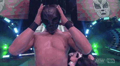 A Man Without A Shirt Is Wearing A Mask And A Tbs Logo Is Behind Him GIF
