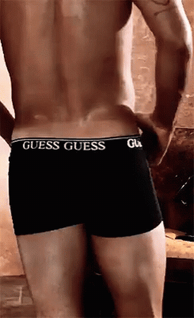 A Man Without A Shirt Is Wearing A Pair Of Guess Underwear GIF