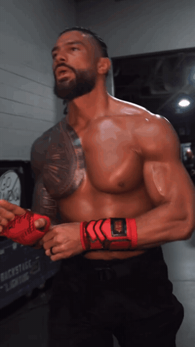 A Man Without A Shirt Is Wearing A Pair Of Red Gloves GIF