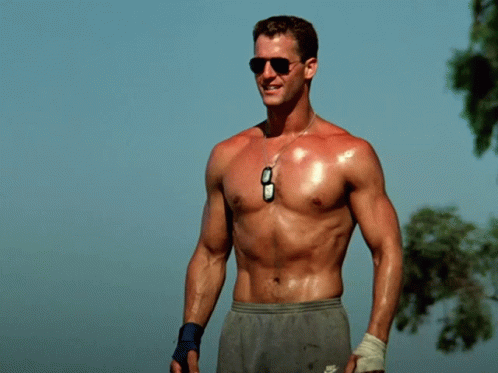 A Man Without A Shirt Is Wearing Nike Shorts And Sunglasses GIF