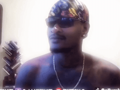 A Man Without A Shirt Is Wearing Sunglasses And A Bandana With A Skull On It GIF