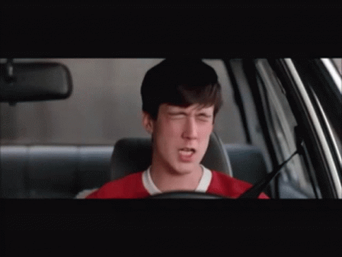 A Man Yawning While Driving A Car With His Mouth Open GIF
