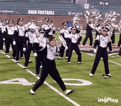 A Marching Band Is Performing On A Field With Ohio Football In The Background GIF