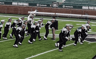 A Marching Band Is Performing On A Field With Ohio Football Written On The Bleachers GIF
