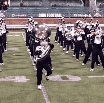A Marching Band Performs On A Field With Ohio Football Banners GIF