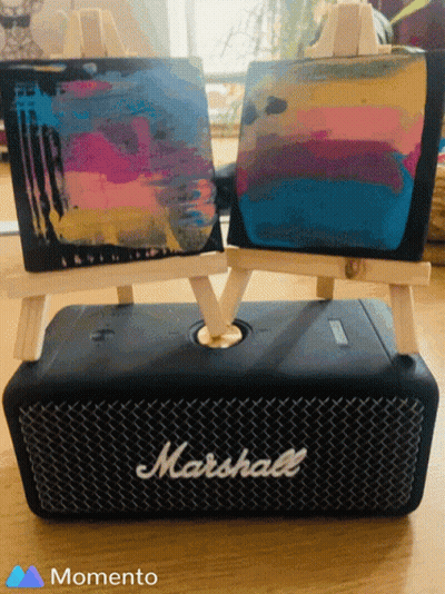 A Marshall Speaker Sits On A Table Next To Two Small Easels GIF