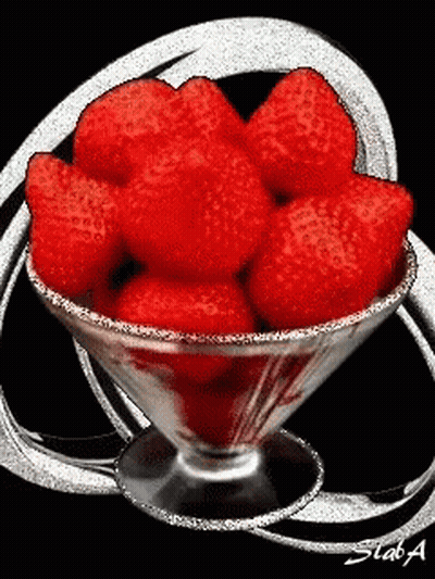 A Martini Glass Filled With Red Strawberries With A Black Background GIF