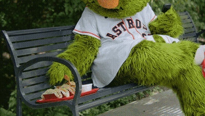 A Mascot For The Astros Sits On A Bench GIF