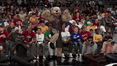 A Mascot For The Cleveland Cavaliers Stands In Front Of A Crowd Of Spectators GIF