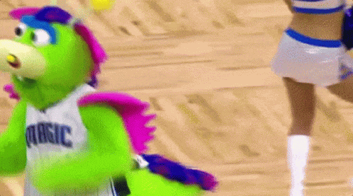 A Mascot For The Dallas Mavericks Is Dancing On A Basketball Court . GIF