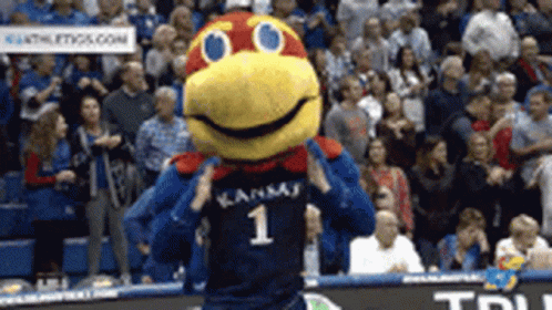 A Mascot For The Kansas Basketball Team Is Dancing On The Court . GIF