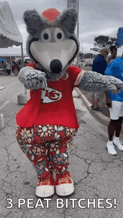 A Mascot For The Kansas City Chiefs Is Standing On A Sidewalk . GIF