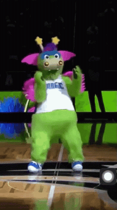 A Mascot For The Magic Basketball Team Is Dancing On A Court GIF