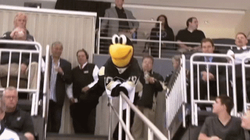 A Mascot For The Penguins Is Walking Down A Staircase GIF