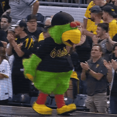 A Mascot For The Pittsburgh Pirates Is Standing In Front Of A Crowd GIF