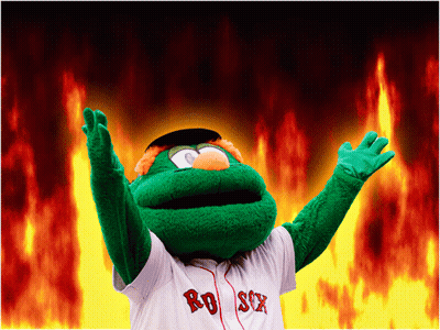 A Mascot For The Red Sox Stands In Front Of A Fire Background GIF