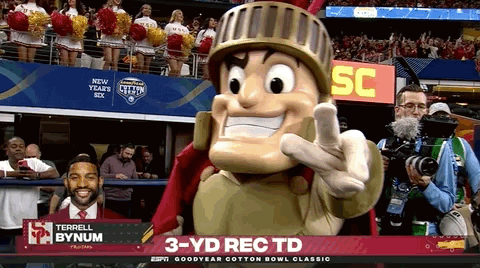 A Mascot Giving A Thumbs Up In Front Of A Screen That Says 3 Yd Rec Td On It GIF