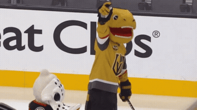 A Mascot In A T-Rex Costume Is Holding A Hockey Stick GIF