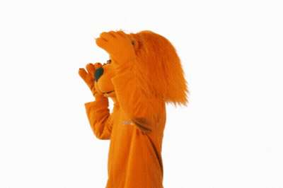 A Mascot In An Orange Ing Lion Costume Waves GIF