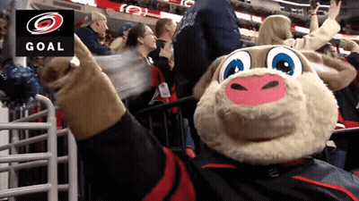 A Mascot In Front Of A Sign That Says Goal On It GIF