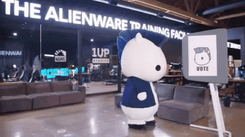 A Mascot In Front Of A Sign That Says " Vote " GIF