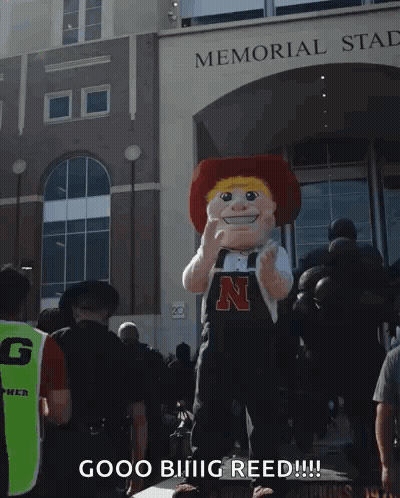 A Mascot In Front Of The Memorial Stadium Says Good Biiiig Reed GIF