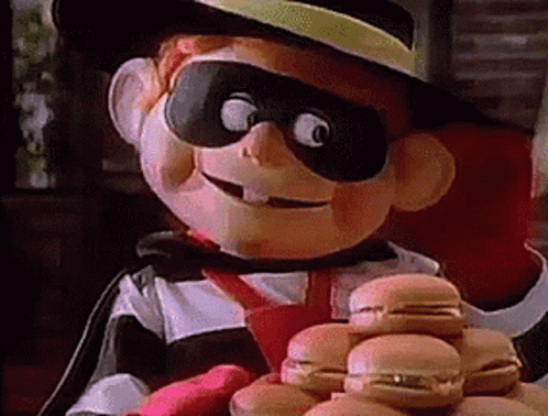 A Mascot Is Holding A Bunch Of Hamburgers In His Hands GIF